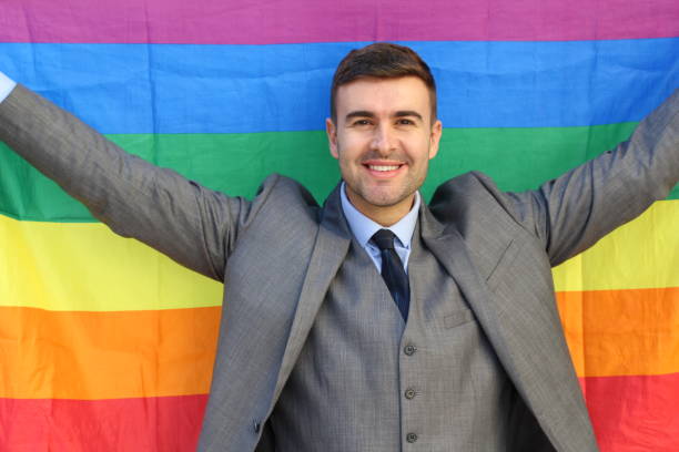 istock Happy businessman holding the rainbow flag 1084728518