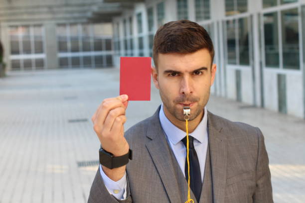 istock Businessman with whistle and red card 1084728592