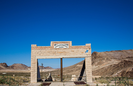 Rhyolite is a ghost town in Nye County, in the U.S. state of Nevada. It is in the Bullfrog Hills, about 120 miles northwest of Las Vegas, near the eastern edge of Death Valley. The town began in early 1905