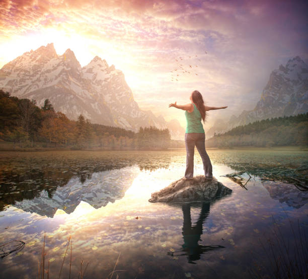 istock Woman giving praise in mountains 1084742648