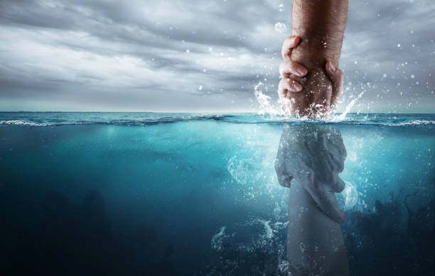 Rescued under water A hand reaches down into the water and saves someone drowning. drowning photos stock pictures, royalty-free photos & images