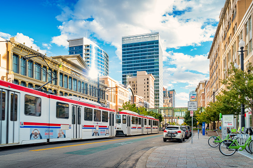 Light rail tram moves in downtown Salt Lake City Utah USA on a sunny day.