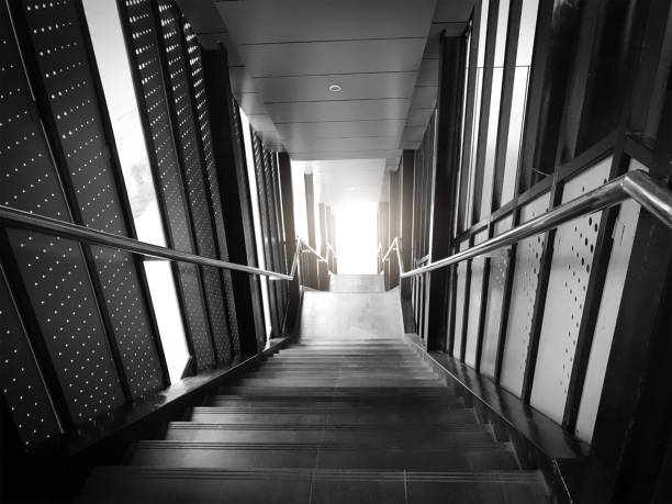 istock High staircase go down to sunshine black and white tone 1084748116