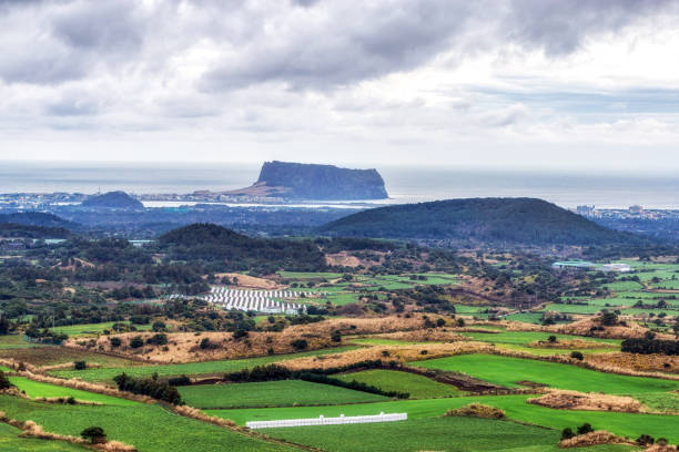 The view of Seongsan Ilchulbong taken from Yongnuni Oreum during winter. Yongnuni Oreum is a famous volcanic crater in Jeju island, South Korea.