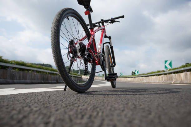 istock Riding Mountain Bike on highway 1084756124