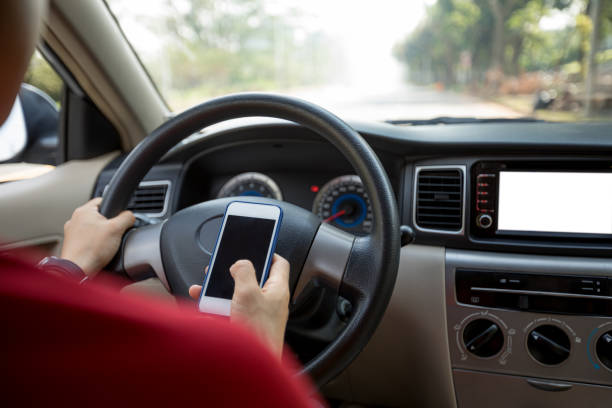 istock Hands holding steering wheel while driving car on city road 1084756300