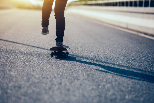 istock Skateboarder skateboarding on city street 1084759650