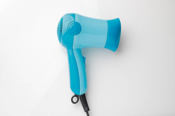 istock Blue hair dryer on white background. 1084761072