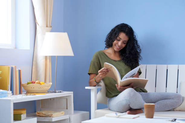 Young woman reading magazine