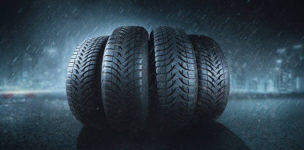 istock Car tires in rain on a road 1084778642