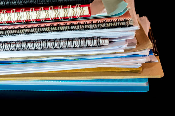 istock Stacked of office documents paper in the black background 1084780556