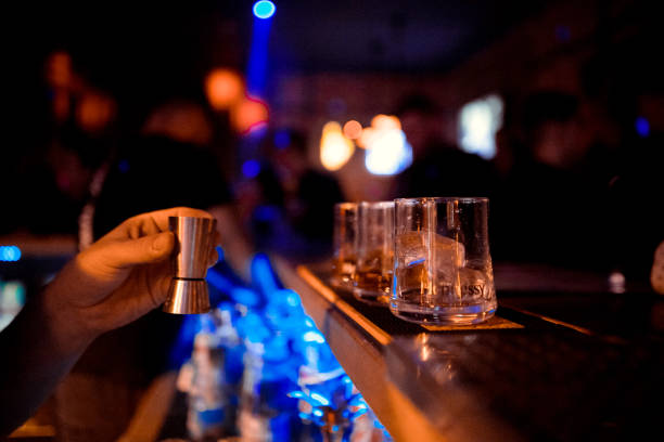 istock Bartender at work in bar pouring drink into measuring glass 1084794126