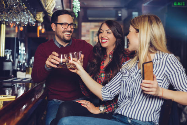 istock Friends got together after work in a bar for a few drinks. 1084800340