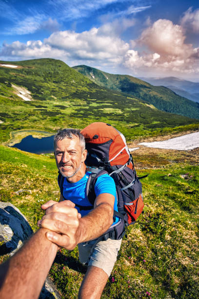 istock A helping hand high in the mountains in the summer hike. 1084800978