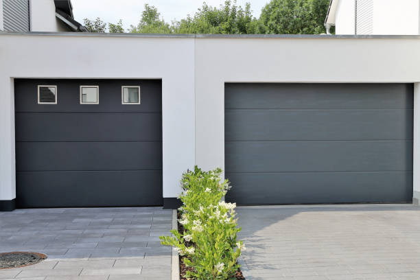 istock Two modern new garage doors (sectional doors) in a residential district 1084812498