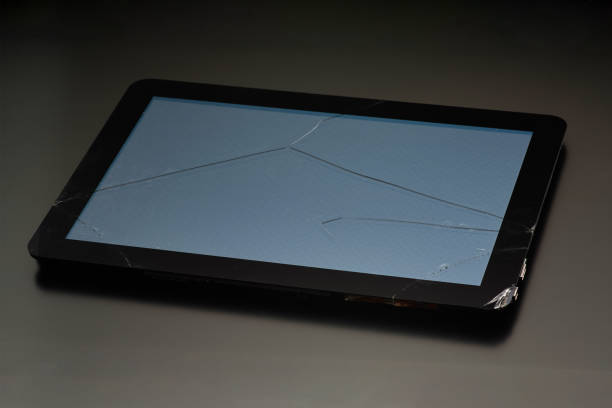 istock The broken screen of the tablet, close-up on a black background 1084816038