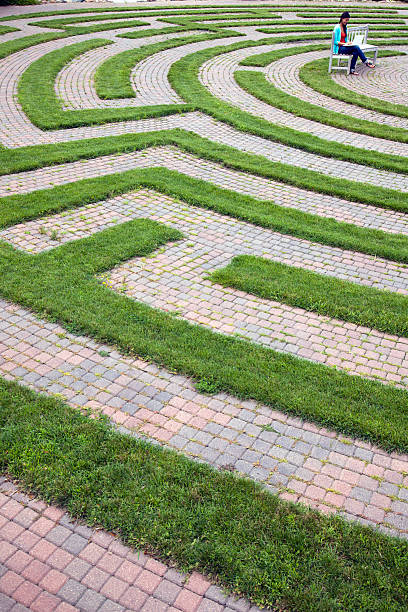 istock Woman Using Laptop in a Cobblestone Maze 108481964