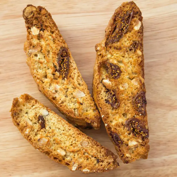 Photo of Classic Italian biscotti cookies on a wooden background. Some festive Christmas biscuits lying on the stand