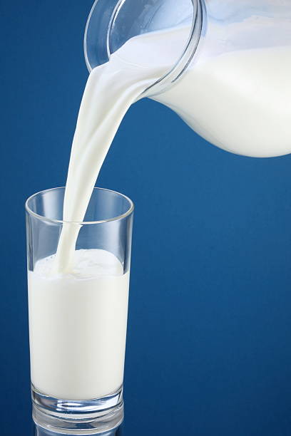 istock milk jug and glass on a blue 108483128