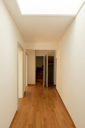 Corridor with parquet and doors in renovated apartment. Nobody inside
