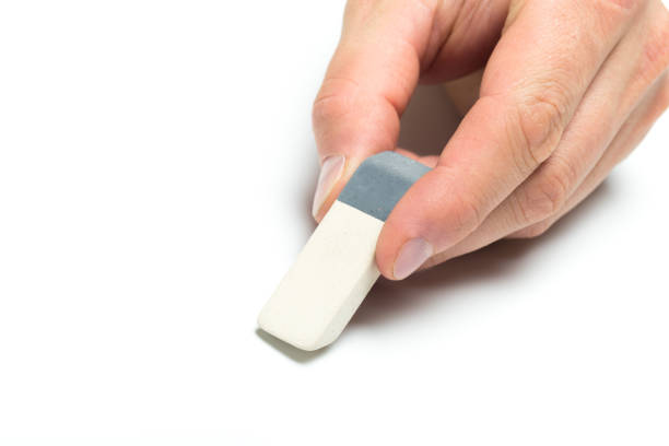 istock Men's hand holding eraser on isolated backgroung, close up 1084836176