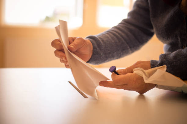 istock Person casting a ballot at a polling station, during elections.
