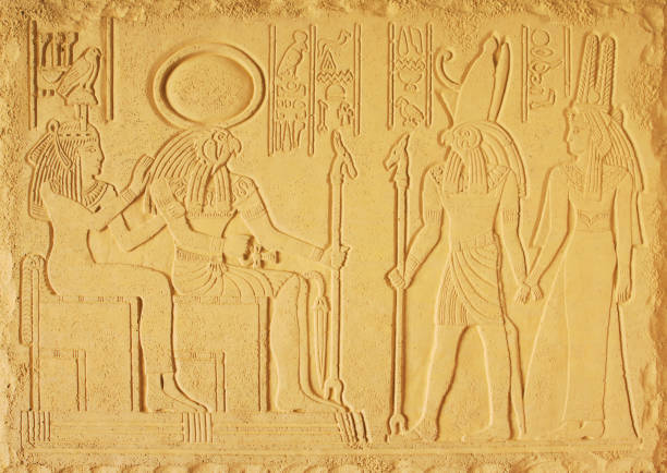 Yellow plaster bas-relief with the gods of ancient Egypt, the God Amon-RA, Horus and the two goddesses Yellow plaster bas-relief with the gods of ancient Egypt, the God Amon-RA, Horus and the two goddesses amon photos stock pictures, royalty-free photos & images