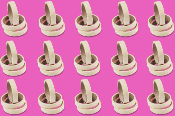 istock Horizontal rows of rolls of adhesive paper tape on pink background. Seamless pattern 1084844706