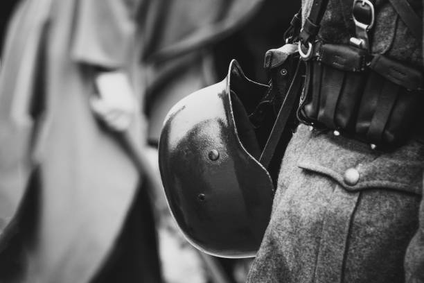 Helmet on the belt with the equipment of the Wehrmacht soldier Battle soldier's helmet army Wehrmacht Germany the second world war. Black and white photography battle reenactment stock pictures, royalty-free photos & images