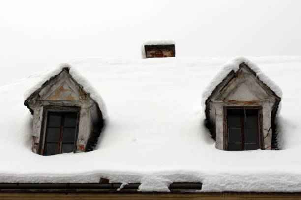 istock Roof windows on old abandoned house covered with deep snow 1084849052