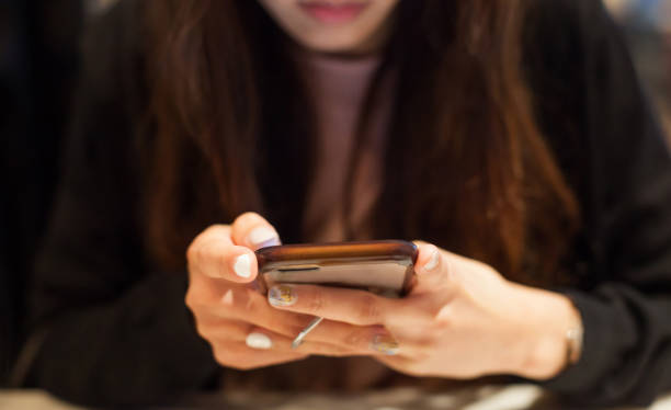 istock Woman using smart mobile phone on the table, Shopping and Communicating with digital technology. Modern Trend, Lifestyle, Business Transaction, Communication, Artificial Society and Mobile App concept 1084850848
