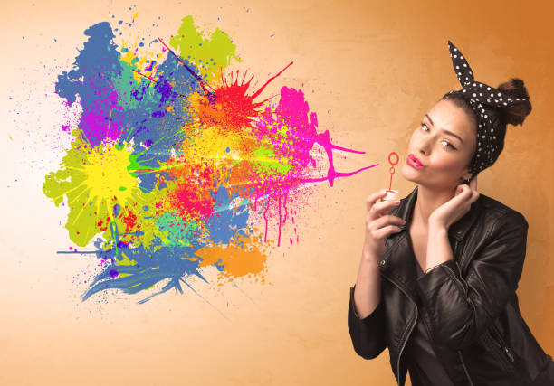 istock Cute girl blowing colorful splash graffiti 1084850956