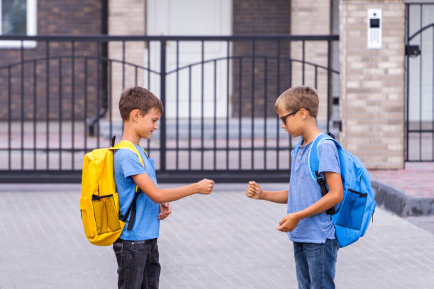 istock Two boys playing rock paper scissors game after school 1084854094