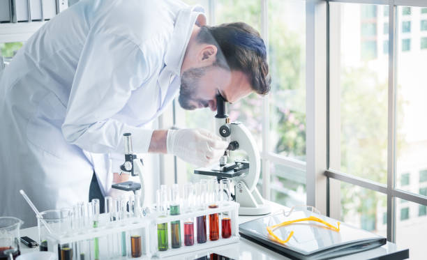 istock Scientists man working and look in to microscope in lab 1084856764