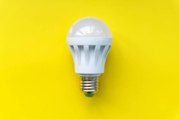 istock Light bulb on yellow background. Fluorescent,  energy savings led lamp. 1084864264