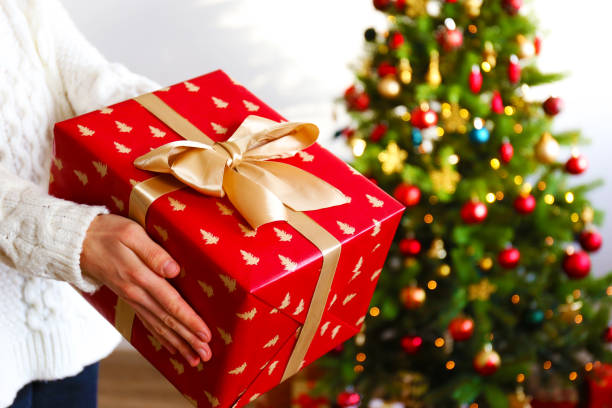 istock Young woman holding colorful present. 1084864540