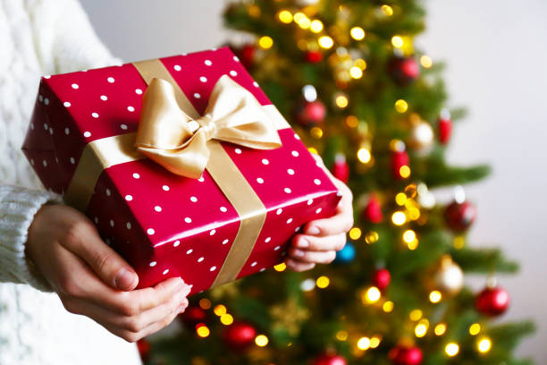 istock Young woman holding colorful present. 1084864666