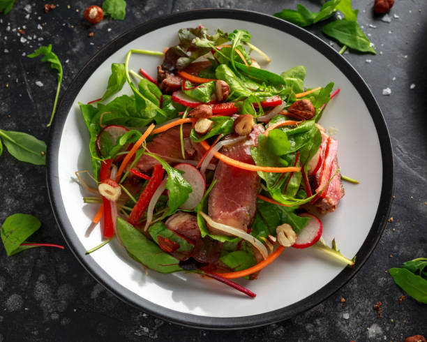 istock Spicy Beef Salad with Carrots, radish, bean sprouts, chilli, nuts and green mix 1084865154
