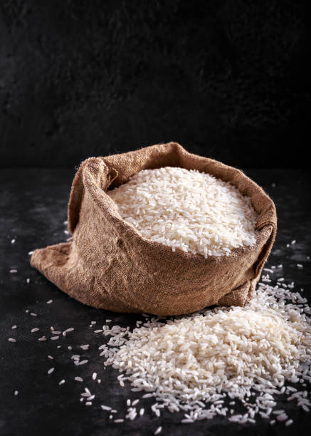 White raw basmati rice in burlap bag. space, text White raw basmati rice in burlap bag. space, text. basmati rice stock pictures, royalty-free photos & images