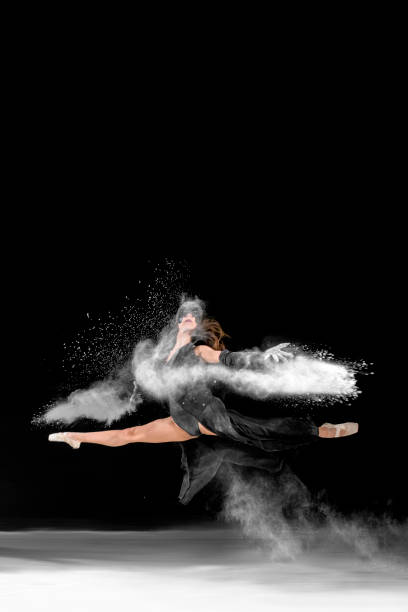 istock Batman masked ballerina dancing with dust 1084867830