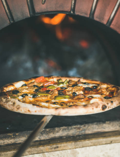 istock Freshly baked pizza with vegetables in wood oven 1084868264