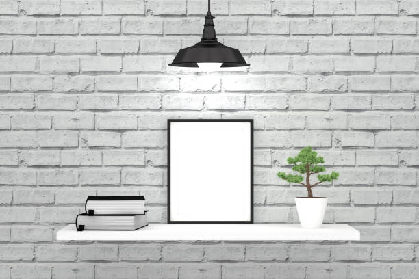 istock White brick wall and shelf with empty frame and old books 1084870924