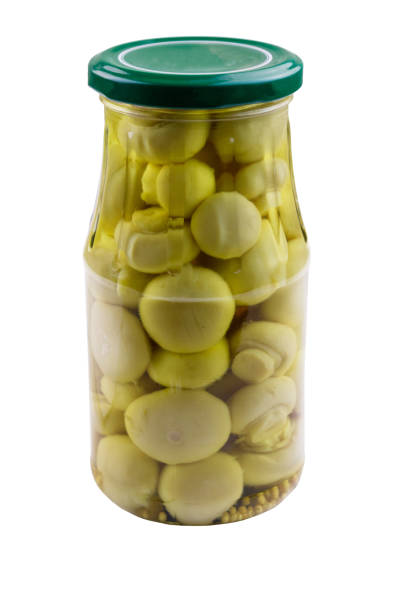 istock Delicious marinated mushrooms in glass jar isolated on white background 1084878766
