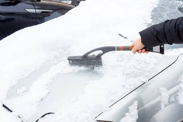 istock cleaning the car from snow 1084883866