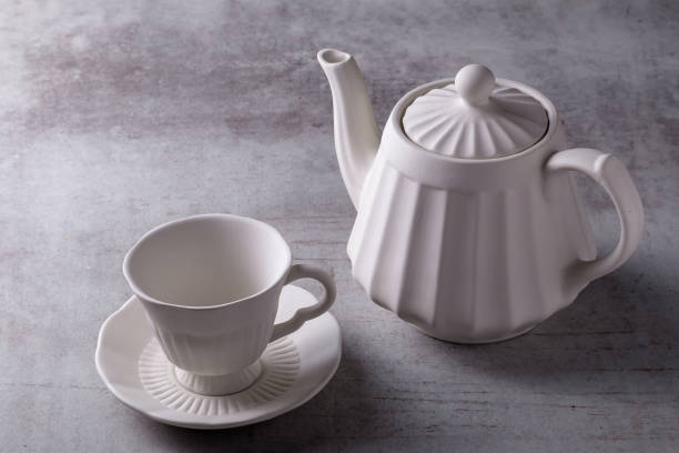 istock Teapot creamer, Cup and saucer on Cement Board 1084885430