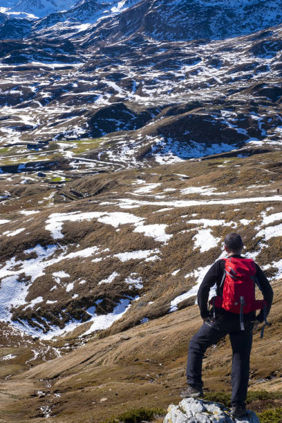istock Man with backpack in front of a snowy landscape 1084885976