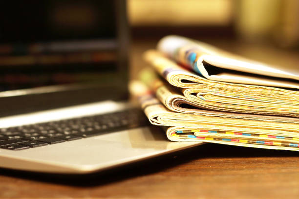 istock Newspapers and laptop 1084891354