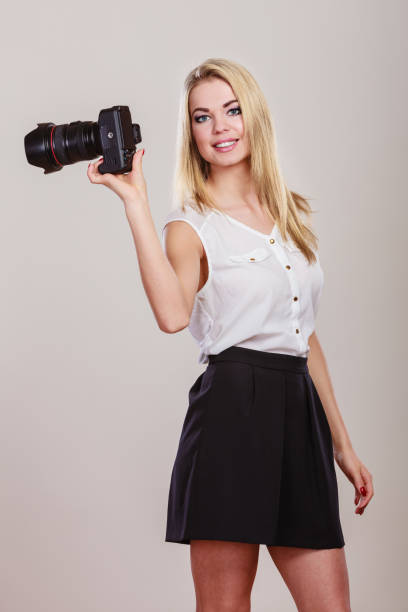 istock Beautiful woman with camera. 1084903374