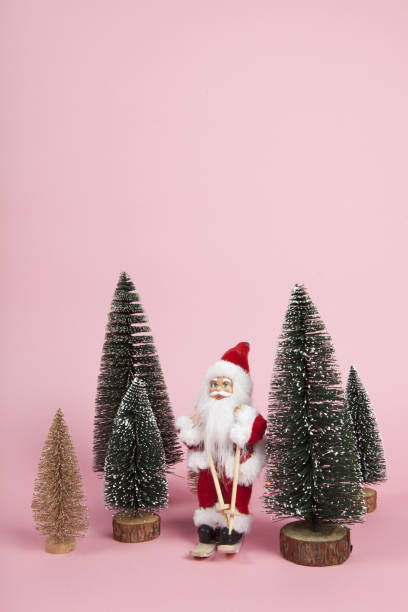 istock Santa Claus skiing on a pink background 1084903588