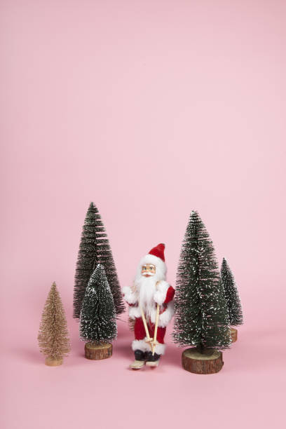 istock Santa Claus skiing on a pink background 1084903620
